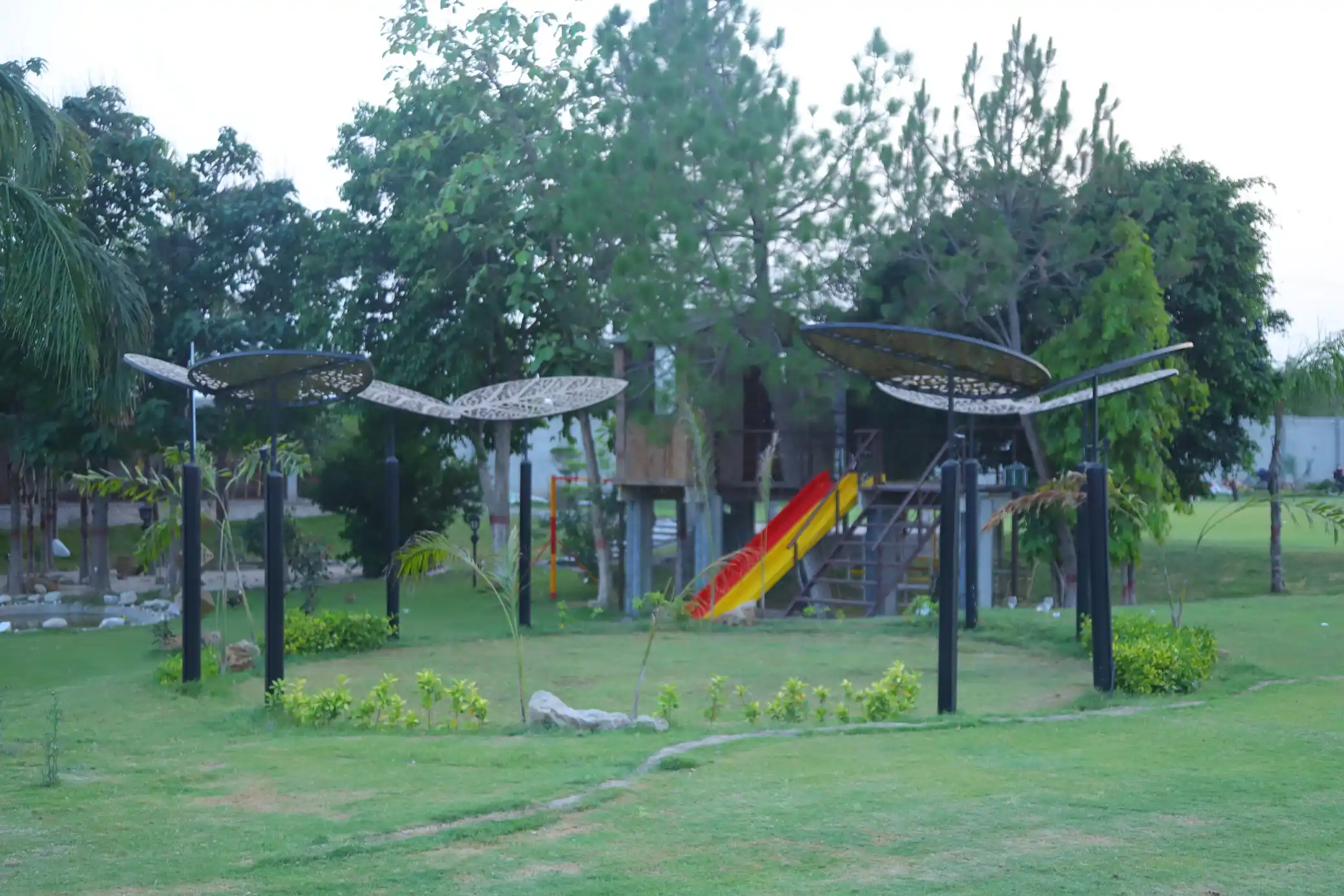 Children play area at Green Meadows Farm with slides and treehouse structure